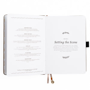Open book with text and decorative elements on a white background