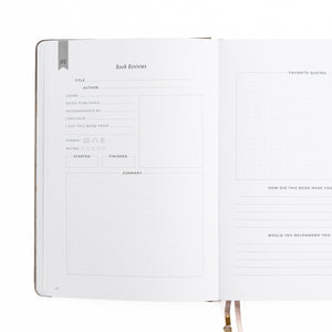 Open notebook with a page dedicated to book reviews on a white background