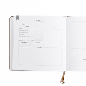 Open notebook with a page titled 'Book Reviews' on a white background