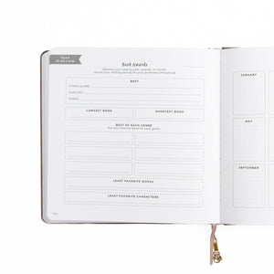 Open planner with book awards section on a white background
